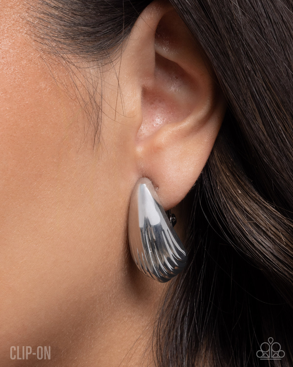 Close-up of Crimped Cover silver teardrop clip-on earrings