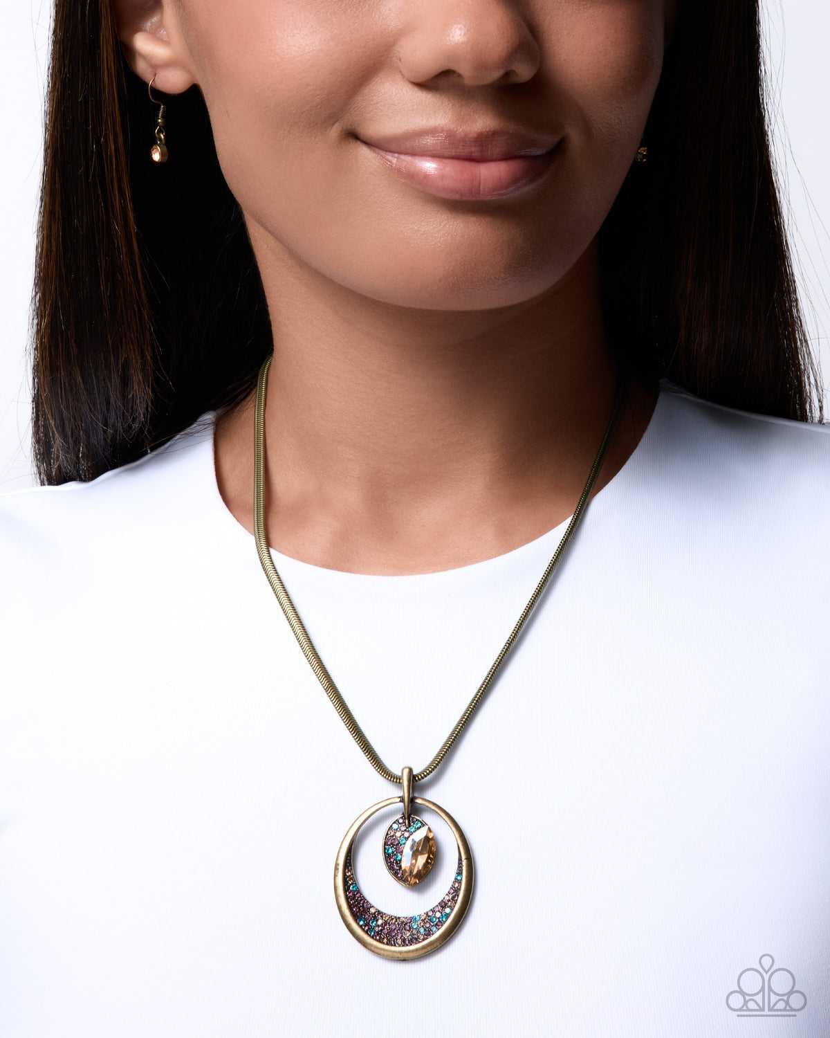 Close-up of Suspended Stardust brass rhinestone pendant necklace with matching earrings