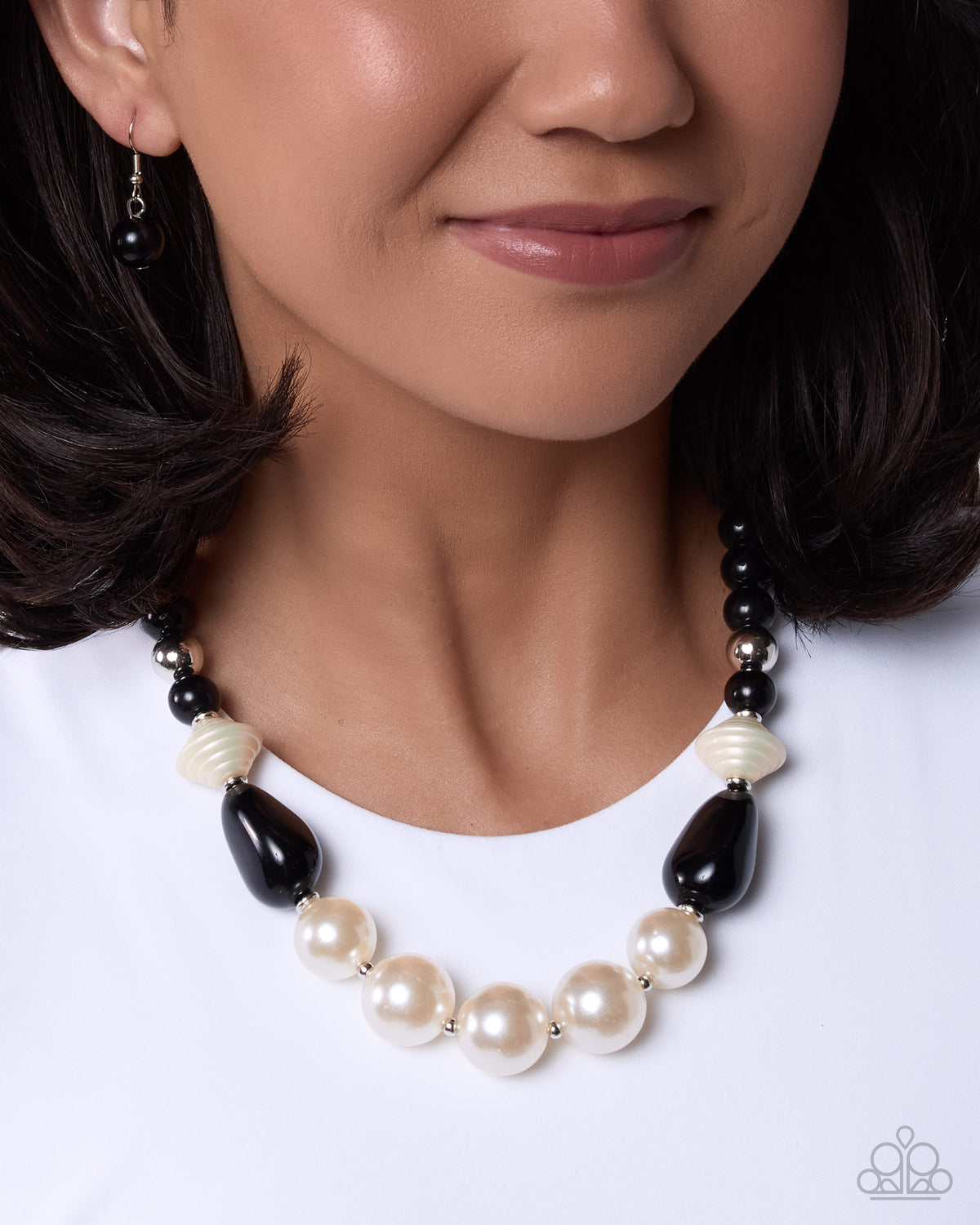 Close-up of Pleasing Pearls black and white pearl necklace with matching earrings