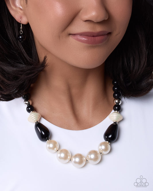 Close-up of Pleasing Pearls black and white pearl necklace with matching earrings