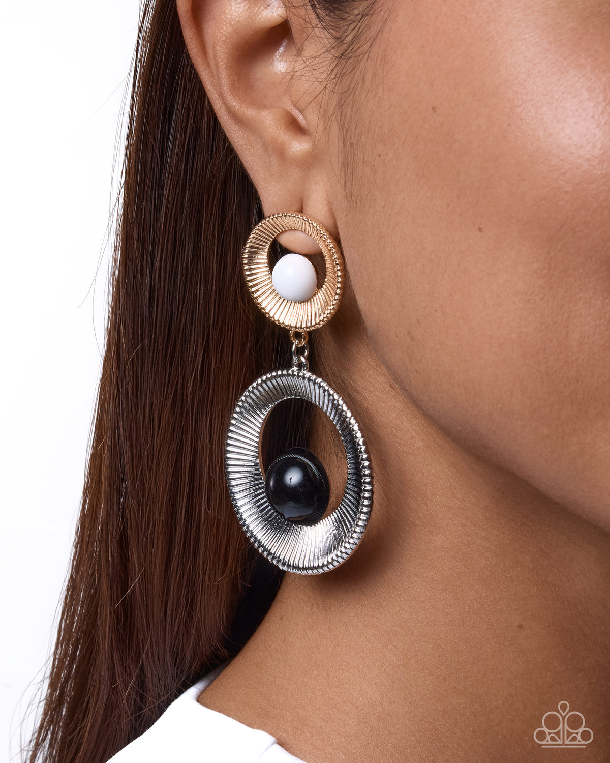 Close-up of Retrospective Reaction gold and silver mixed-metal hoop earrings